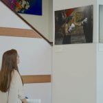 Student looks at photos for IWD exhibition
